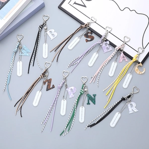 Chic acetate alphabet keychains with heart clips and woven tassels in various styles