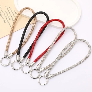 Close-up of sparkling rhinestone tube wristlet straps with metal rings in five colors