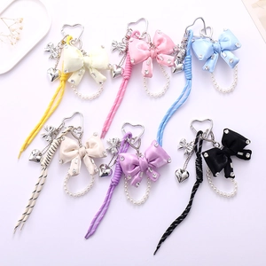 Bowknot phone charms with rhinestones and woven nylon straps in six pastel colors