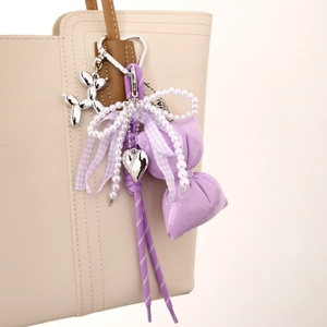 Sweet purple phone charm with pearl bow, silver balloon dog, and heart pendant accessory