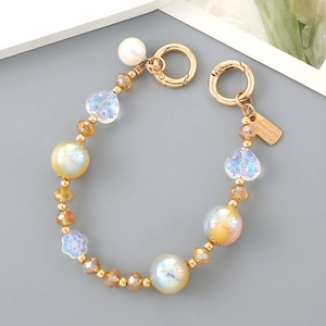Detailed macro of crystal heart beaded strap with golden spring clasps and colorful pearls
