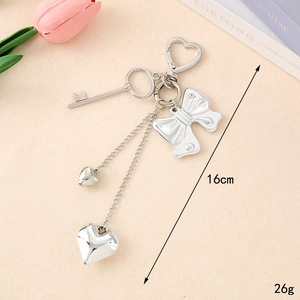 Silver Y2K bow and heart keychain charm measuring 16cm in length and 26g in weight