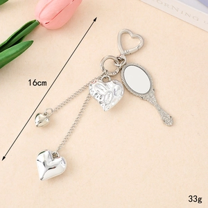 Chic silver Y2K heart keychain with mirror charms and bow detail for bags, 16cm length