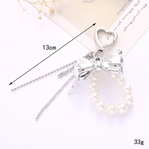 Elegant 13cm pearl bow keychain with silver heart clasp and layered beaded chain for bags