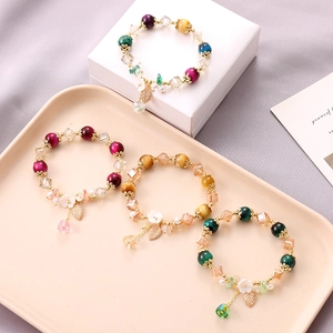 Tiger eye bead bracelets with floral and leaf charms in a stylish group display