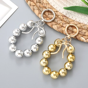 Metallic beaded charm with bow detail and ring clasp for bags and car keys