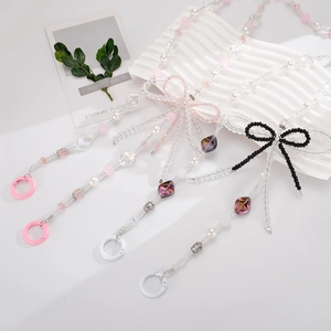 Crossbody crystal bow beaded phone lanyard with pearls and butterfly accents