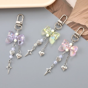 Three colorful acrylic bow pendants with star and heart charms for bags and keys