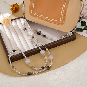 Chic beaded phone strap with black flower detail and cross-body metal hooks