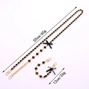 Detail of hand-woven gold chain with black ribbon bow and size dimensions shown