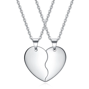 Polished stainless steel heart puzzle necklace for couples on a white background