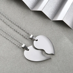 Polished stainless steel heart puzzle necklace with two interlocking half heart pendants