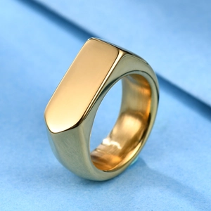 Top view of a gold rectangular signet ring with a polished mirror finish on a light blue background