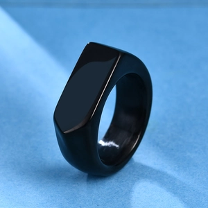 Macro shot of minimalist black stainless steel signet ring with flat rectangular surface