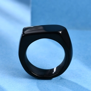 Close-up of a 9mm polished black stainless steel signet ring on a modern background