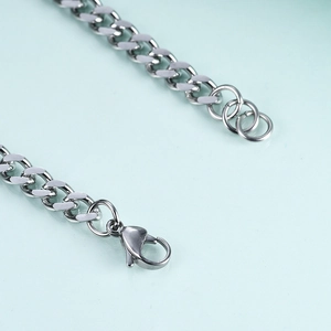 Close-up of a 7mm stainless steel chain with secure lobster clasp and adjustable ring links