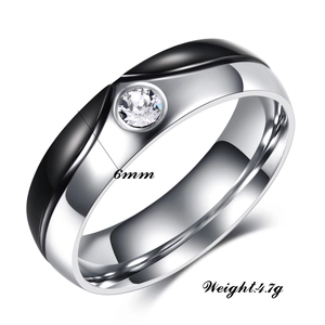 Macro detail of 6mm two-tone stainless steel ring with center crystal and curved design