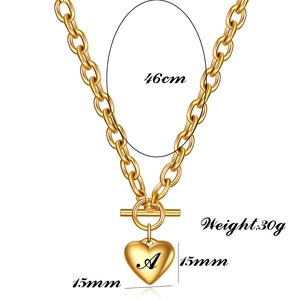 Detailed view of 18K gold heart pendant necklace with letter A and OT toggle clasp
