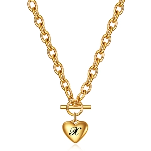Detailed macro view of 18K gold chunky chain necklace with heart pendant and letter X