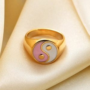 Macro detail of 18K gold stainless steel ring with pink and white Tai Chi enamel inlay