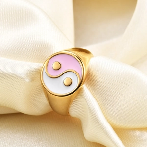 Close-up of 18K gold stainless steel ring featuring pink and white Yin Yang enamel design