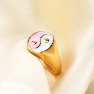 Detail of pink and white enamel Yin Yang symbol on 18K gold plated stainless steel ring