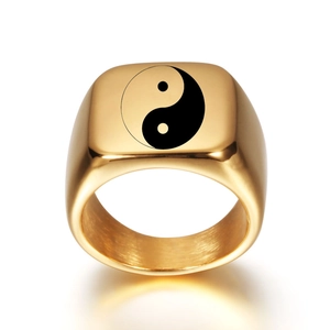 Macro view of gold signet ring featuring laser engraved black and white Tai Chi symbol