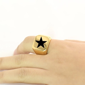 Close-up of gold-plated square signet ring with black star engraving on male finger