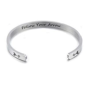 Minimalist stainless steel cuff bangle with Follow Your Arrow engraving and arrow details