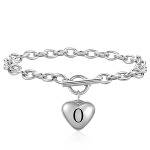 Detail of silver heart charm with letter O on a toggle clasp cable chain bracelet
