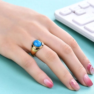 Détail de la bague en acier inoxydable doré 18K avec turquoise ovale portée à la main
