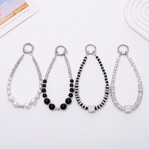 Detail of luxury beaded phone charms with pearls, rhinestones, and silver metal clasps