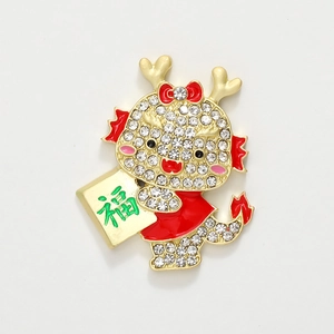 Macro detail of cartoon dragon brooch with white rhinestones and a red Fu character