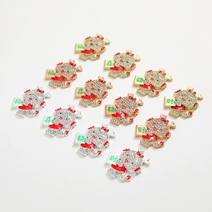 Detail of 12-piece dragon charm set with rhinestones and lucky Chinese characters