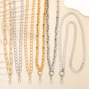 Elegant gold and silver aluminum phone straps with metal clasps on a minimalist background