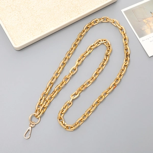Detailed close-up of shiny gold metal chain strap with polished lobster clasp and ring
