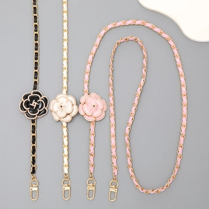 Detail of leather woven metal chains with camellia flower charms in black white and pink