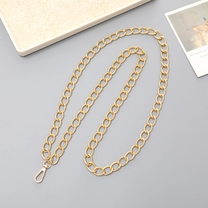 Detail of gold aluminum chain strap with textured oval links and lobster clasp