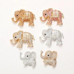 Detailed view of elephant charms with champagne and pink rhinestones on a white background