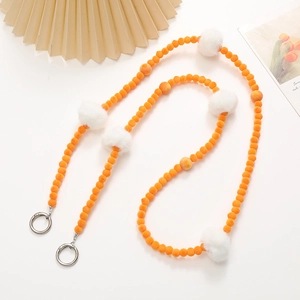 Crossbody phone strap featuring orange plush beads and white faux fur pom poms with silver clips
