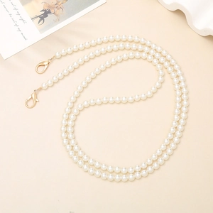 Elegant white faux pearl phone strap with golden metal lobster clasps for crossbody use