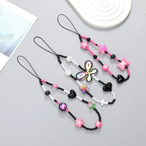 Pink Y2K beaded phone charms with butterfly heart and star charms on display