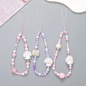 Close-up of handmade beaded phone lanyards featuring cartoon rabbit and king letter beads