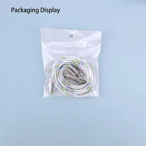 Colorful woven crossbody phone lanyard strap with silver metal lobster clasps in packaging