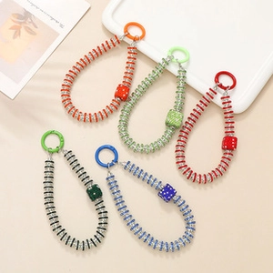 Detail of colorful spiral phone charms with crystal square pendants and spring ring clasps