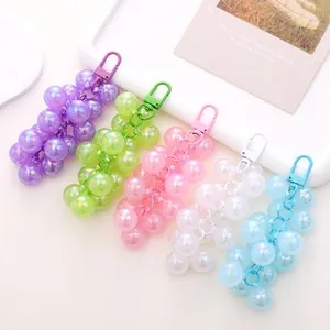 Detail of colorful resin grape charms with iridescent coating and matching lobster clasps