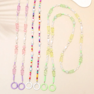 Detail of colorful beaded phone lanyards with acrylic bears and faux pearl accents