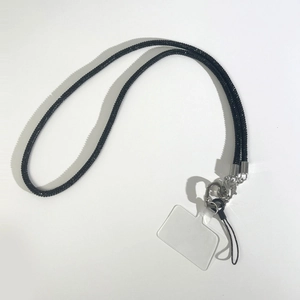Detail of black rhinestone phone lanyard with silver metal lobster clasp and clear patch