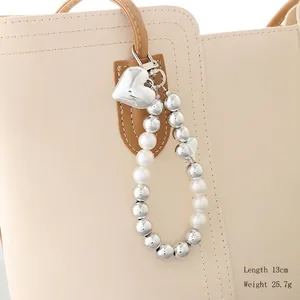 Silver beaded heart pendant bag charm with pearls and bow details, 13cm length