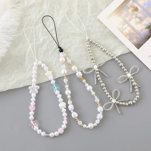 Handmade beaded phone charms with pearls, ribbons, and heart pendants in diverse styles
